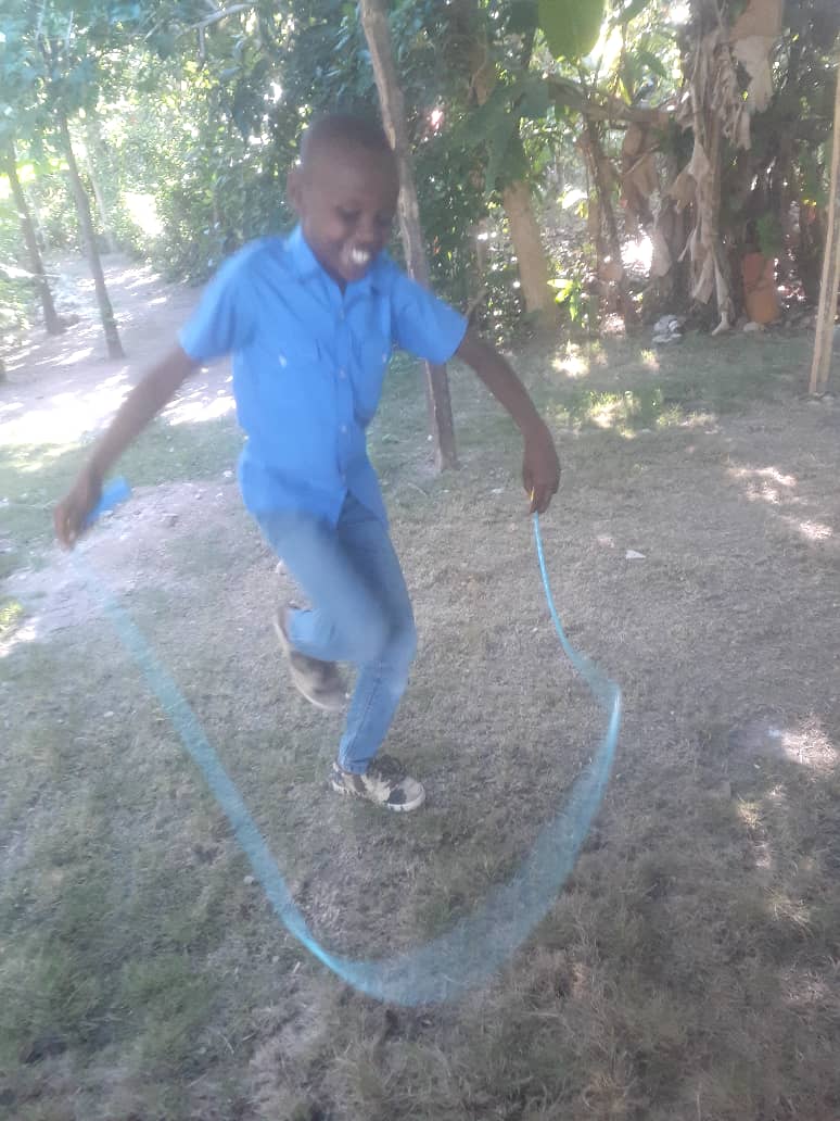 Boy jumping rope in the yard